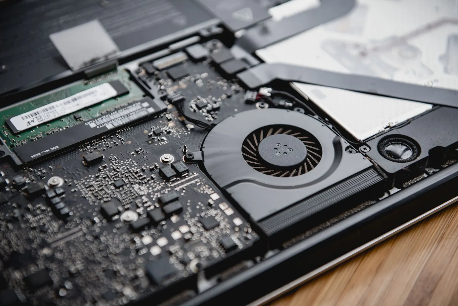 Interiorul unui laptop: memorie RAM, ventilator și placa de bază
